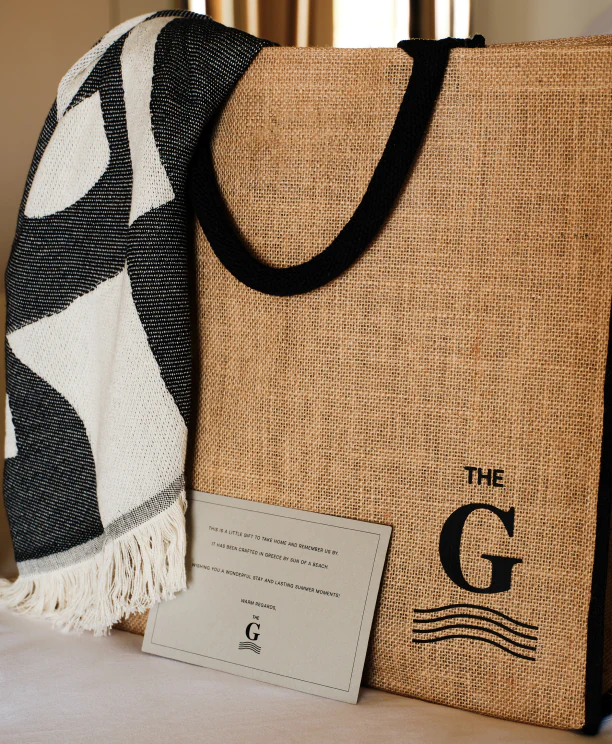 A stylish hospitality welcome gift bag placed elegantly, showcasing luxury branding.